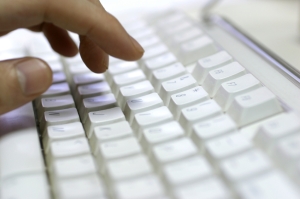 Hand typing at a keyboard